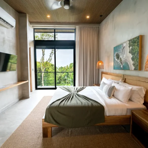 Custom wood bedroom at Manuel Antonio Tree House Villa featuring natural wood finishes, modern furnishings, and jungle views.
