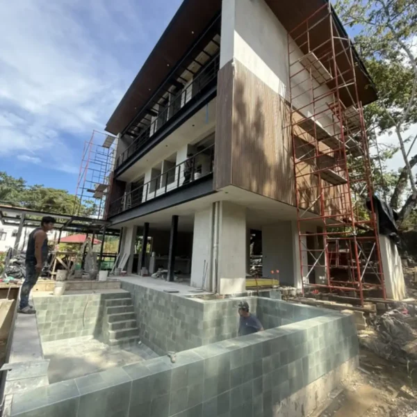 Exterior construction progress at Manuel Antonio Tree House Villa with completed structural framework, and tiled plunge pool.