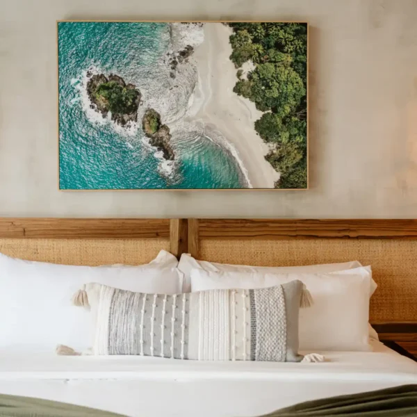 Luxury jungle-inspired bedroom at Manuel Antonio Tree House Villa with large windows and tropical views.