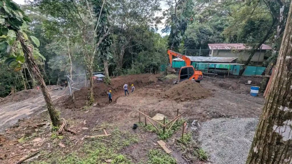 Site preparation and initial excavation at Manuel Antonio Tree House Villa, showing hillside clearing and grading prior to foundation installation.